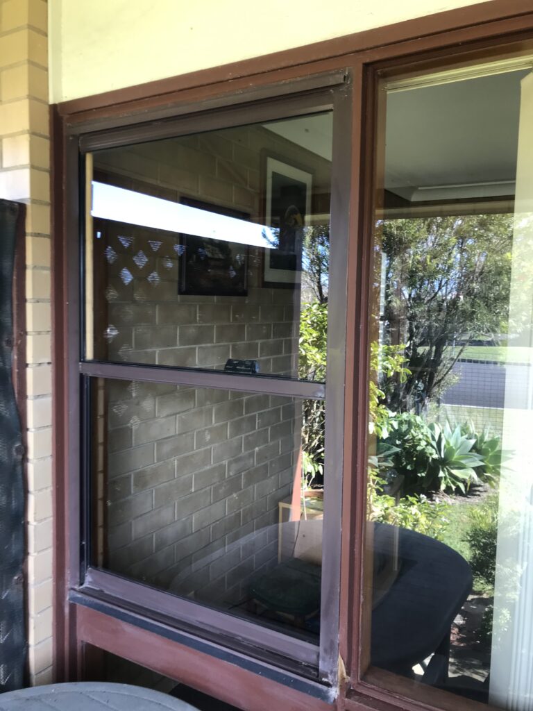 Window cleaner removing dirt and salt residue from glass