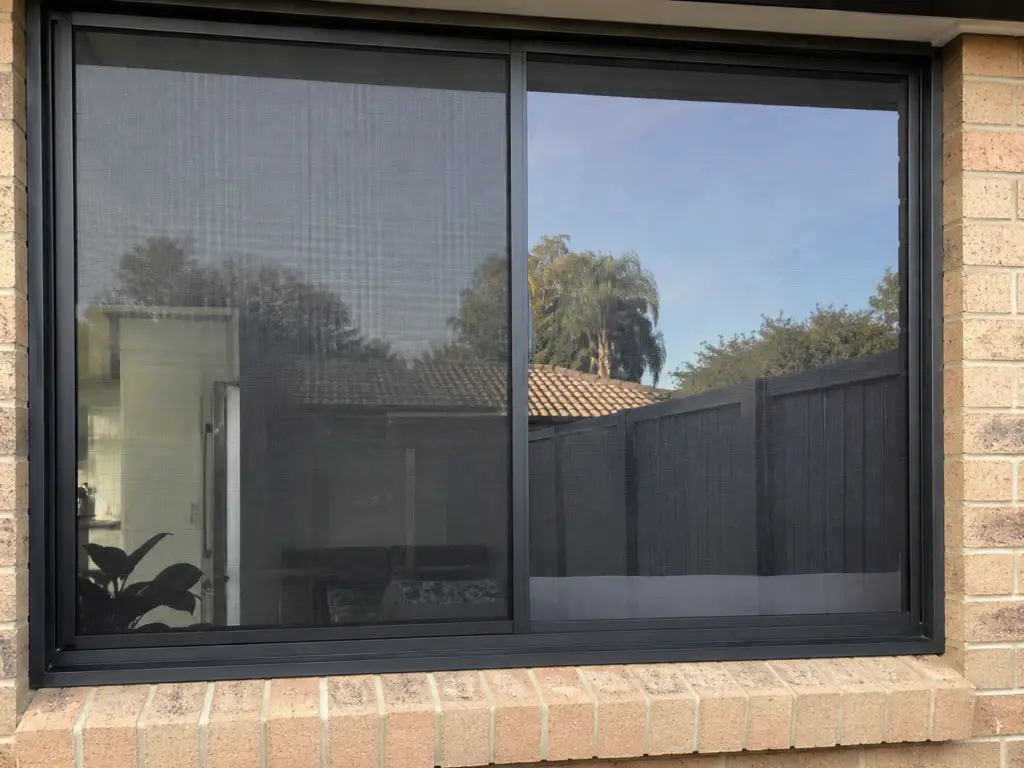 Professional window cleaner washing exterior glass